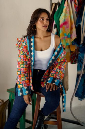 A quilted statement jacket Drawn in by the Aravani Art Project with artwork representing flowers that have a big significance in the space of being gender-fluid is vibrant and bespoke